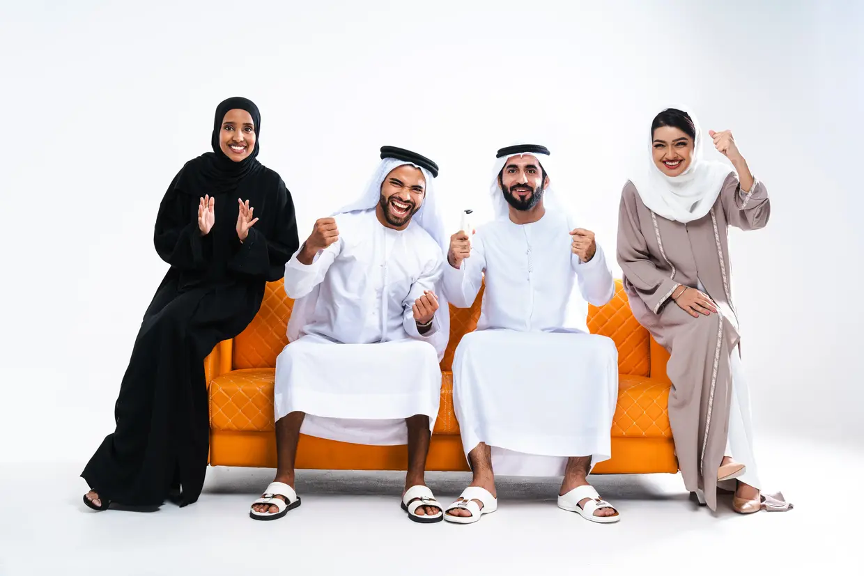 Emirati family celebrating while enjoying IPTV Dubai subscription – the best IPTV subscription experience in the UAE.